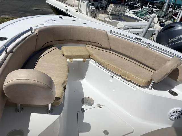 Slide: The Image of 2020 Sportsman Open 242 boat with beige seating and spacious deck layout. - 8