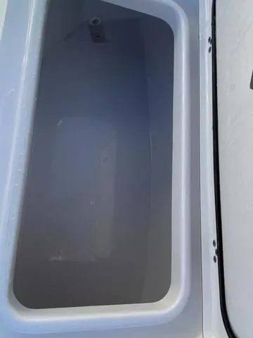 Slide: The Image of 2020 Sportsman Open 242 boat storage compartment, empty and clean. - 9