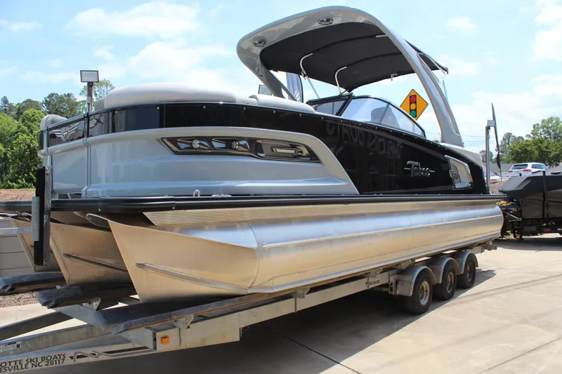 The Image of 2023 Tahoe Pontoon Grand Tahoe 25' on trailer, sleek design, sunny day. - 1