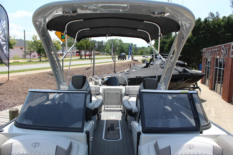 Slide: The Image of 2023 Tahoe Pontoon Grand Tahoe 25' boat with dual consoles and canopy, displayed outdoors. - 12