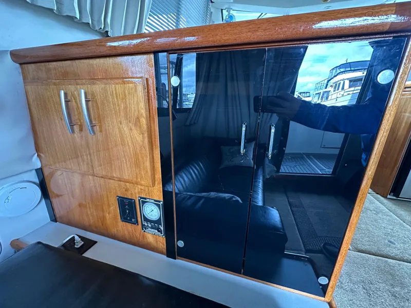 Slide: The Image of 1994 Carver 370 Voyager interior with wooden cabinetry and glass doors. - 24