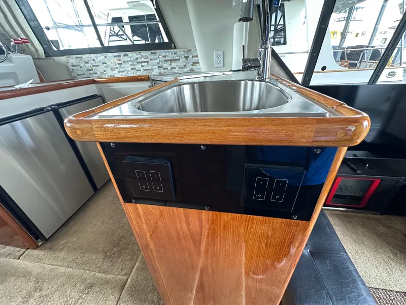 Slide: The Image of 1994 Carver 370 Voyager yacht interior with wooden sink counter and modern appliances. - 27