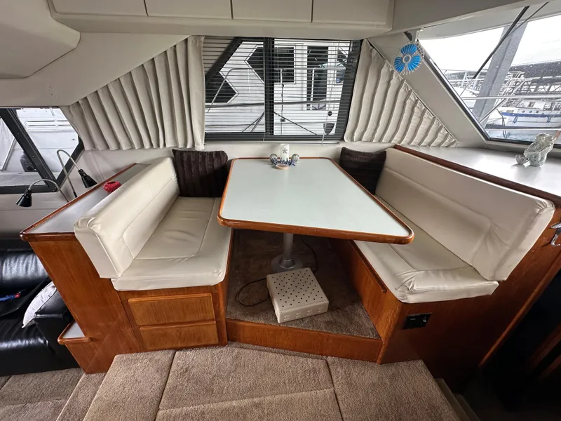 Slide: The Image of Interior of a 1994 Carver 370 Voyager yacht with a cozy dining area. - 32