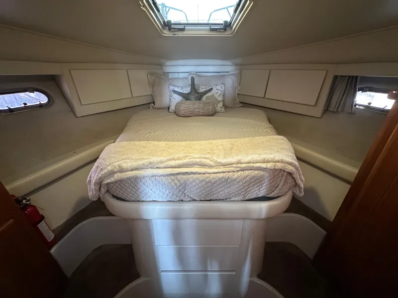 Slide: The Image of Cozy cabin interior of 1994 Carver 370 Voyager with a neatly made bed. - 38