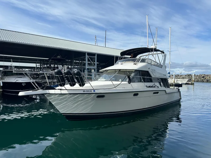 Slide: The Image of 1994 Carver 370 Voyager yacht docked in marina, under clear blue sky. - 4
