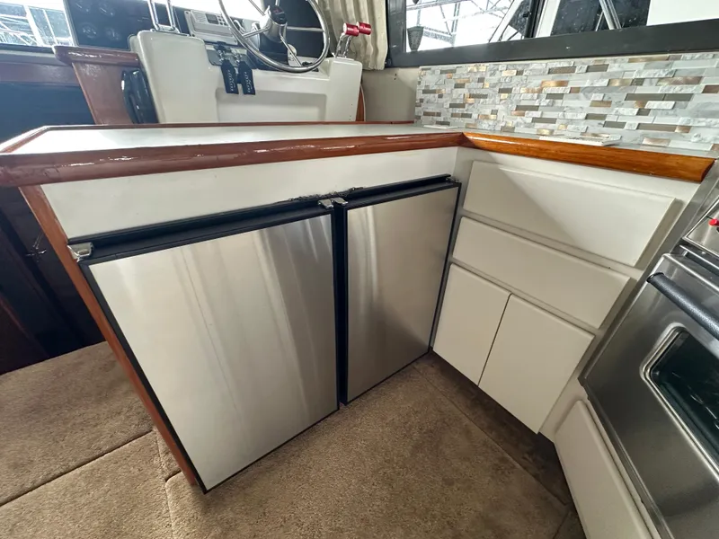 Slide: The Image of 1994 Carver 370 Voyager yacht kitchen with stainless steel appliances and modern backsplash. - 43