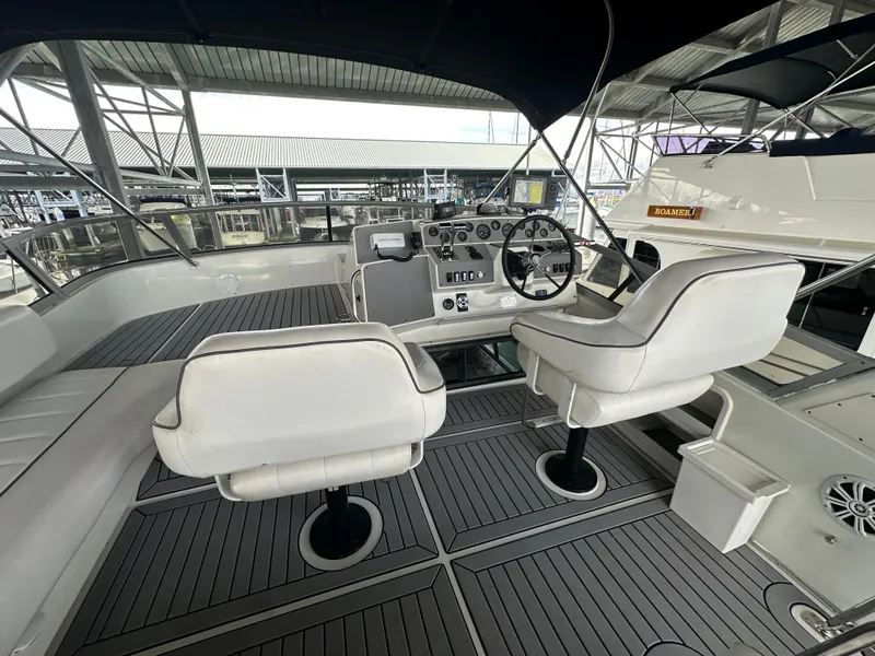 Slide: The Image of 1994 Carver 370 Voyager yacht cockpit with helm, white seats, and modern controls. - 13