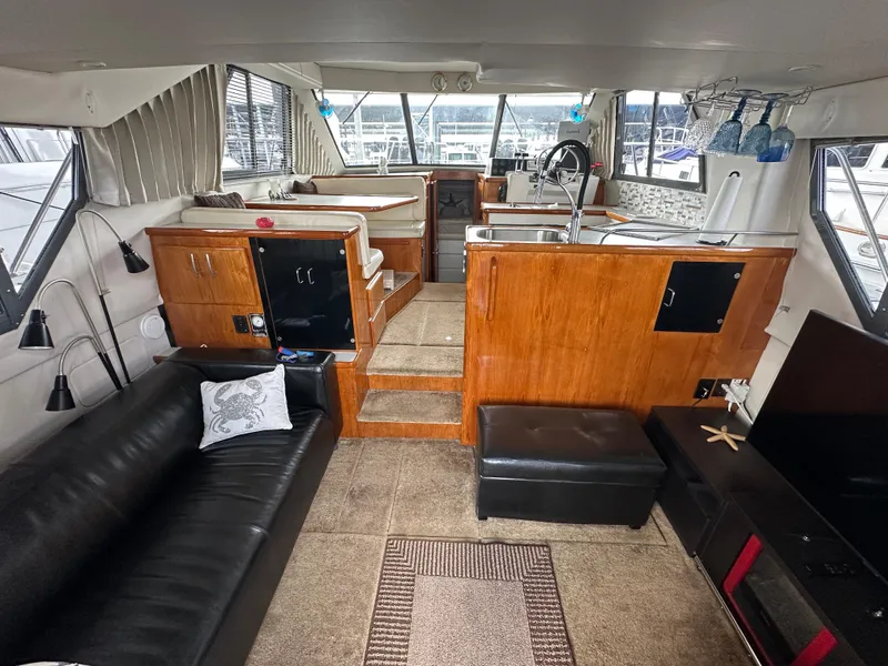 Slide: The Image of Interior of 1994 Carver 370 Voyager yacht with modern furnishings and spacious layout. - 22