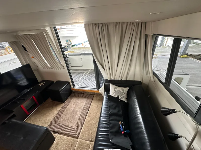 Slide: The Image of Interior of 1994 Carver 370 Voyager yacht with leather seating and large windows. - 28