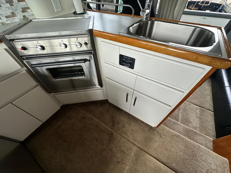 Slide: The Image of Compact kitchen area in a 1994 Carver 370 Voyager yacht with stove and sink. - 29