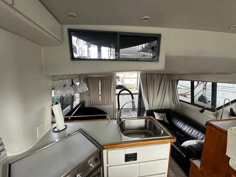 Slide: The Image of Interior of 1994 Carver 370 Voyager yacht with kitchen and seating area. - 31