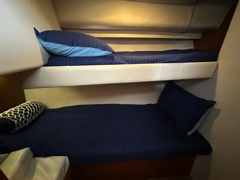 Slide: The Image of Bunk beds in 1994 Carver 370 Voyager yacht cabin with blue bedding. - 36