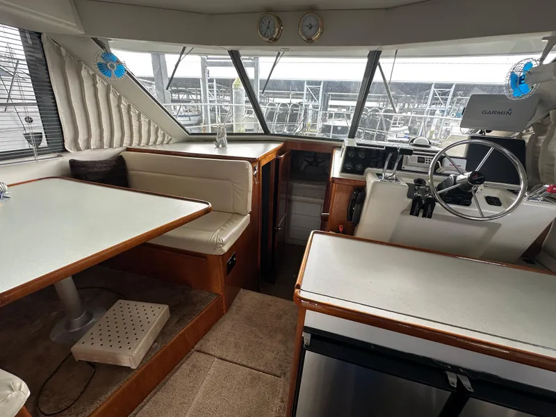 Slide: The Image of Interior of 1994 Carver 370 Voyager yacht with helm, seating, and dining area. - 46