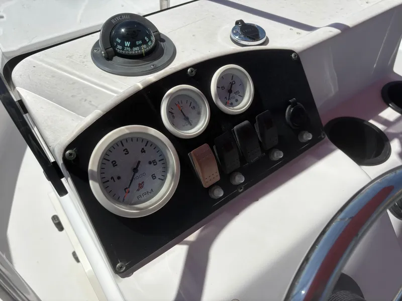 Slide: The Image of Dashboard of a 2004 Boston Whaler 170 Montauk boat with gauges and compass. - 10