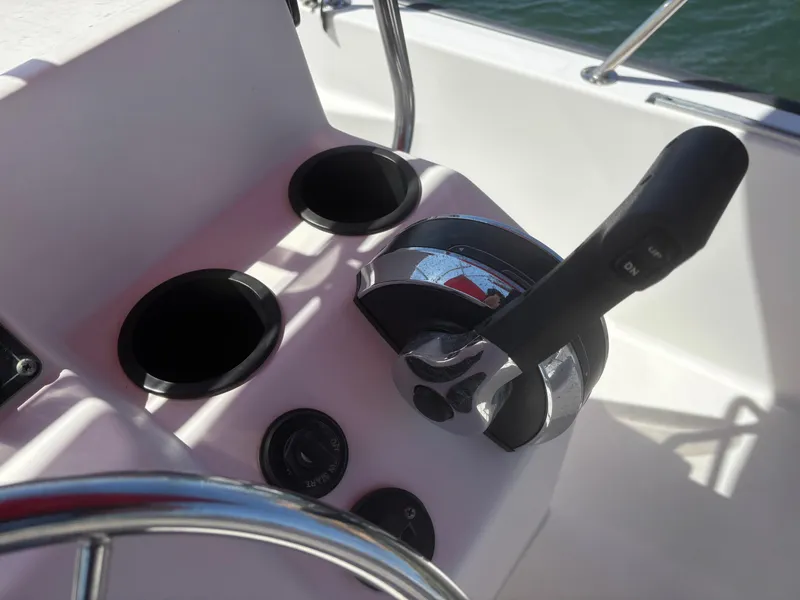 Slide: The Image of Control panel of a 2004 Boston Whaler 170 Montauk boat with throttle and cup holders. - 11