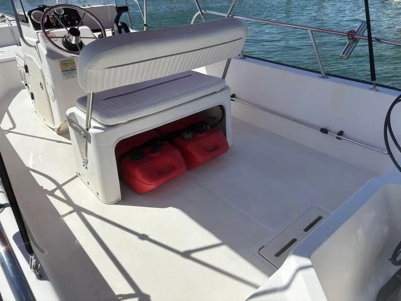 Slide: The Image of 2004 Boston Whaler 170 Montauk boat interior with seating and storage compartments. - 13