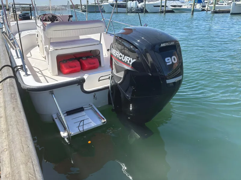 Slide: The Image of 2004 Boston Whaler 170 Montauk with Mercury 90 engine docked in marina. - 15