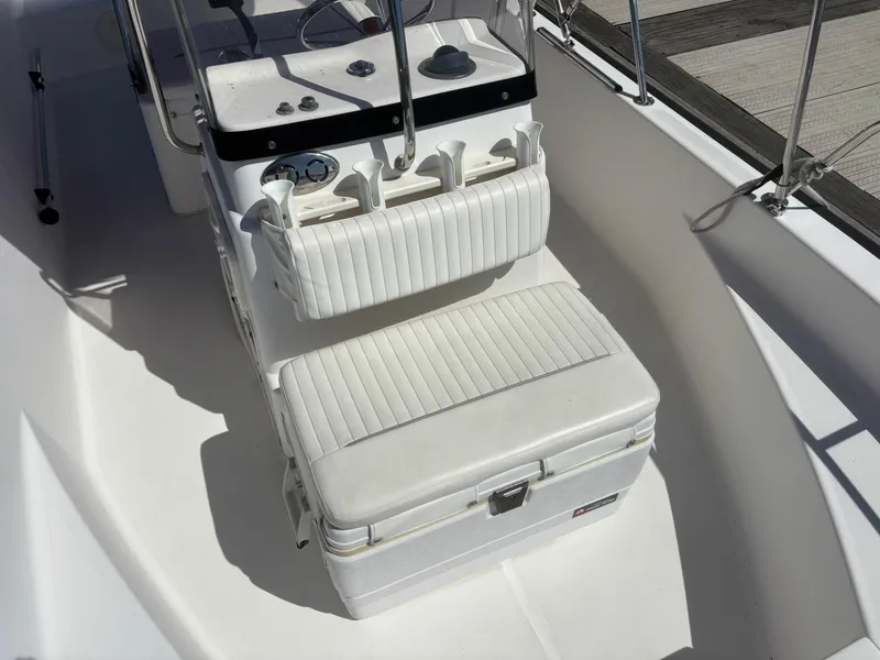 Slide: The Image of 2004 Boston Whaler 170 Montauk boat interior with white seating and console. - 4