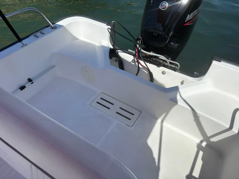 Slide: The Image of 2004 Boston Whaler 170 Montauk boat interior with Mercury outboard motor. - 6