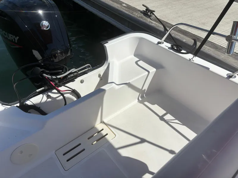 Slide: The Image of 2004 Boston Whaler 170 Montauk boat interior with Mercury outboard engine. - 7