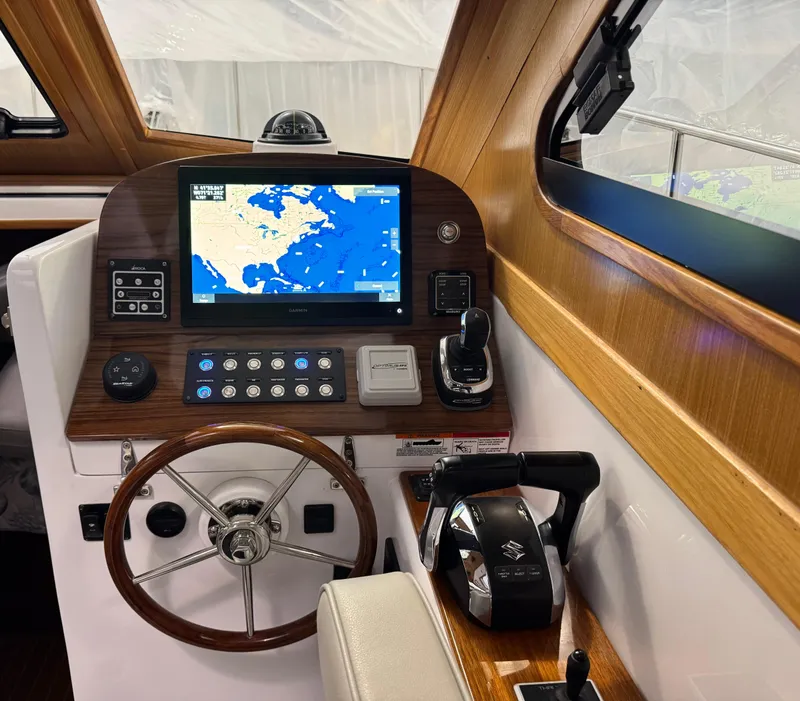 Slide: The Image of 2022 True North 34 Outboard Express helm with navigation display and controls. - 12
