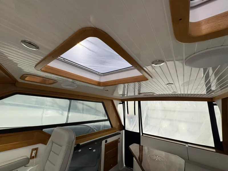 Slide: The Image of Interior of 2022 True North 34 Outboard Express with skylights and modern seating. - 16