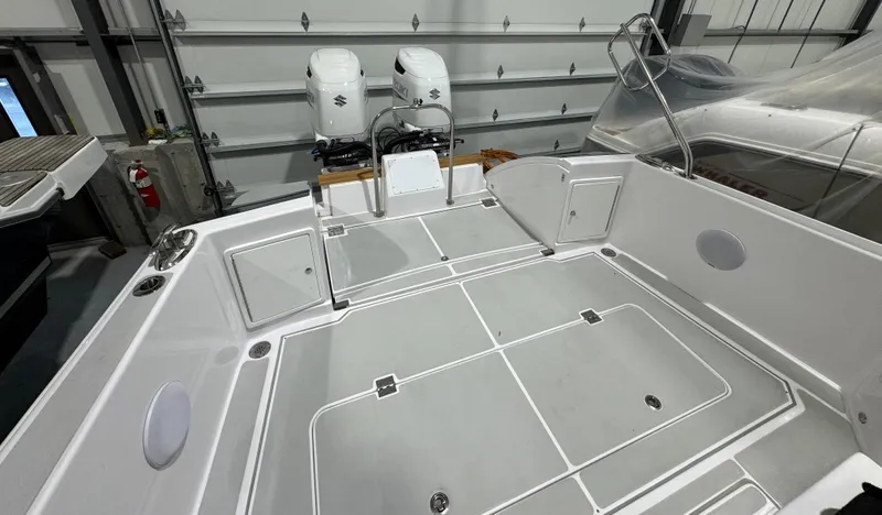 Slide: The Image of 2022 True North 34 Outboard Express boat interior with dual engines in a garage. - 19