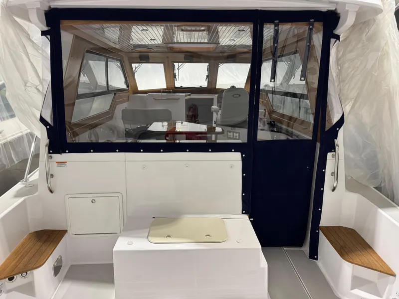 Slide: The Image of 2022 True North 34 Outboard Express boat interior with seating and helm. - 2