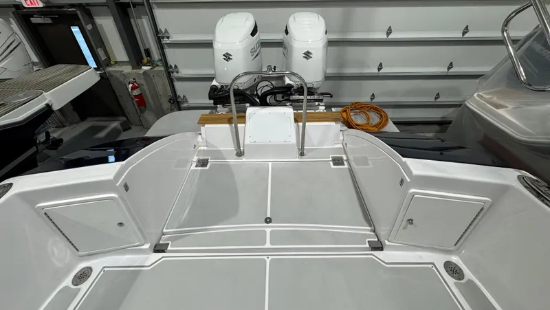 Slide: The Image of 2022 True North 34 Outboard Express boat with dual engines in a garage. - 20