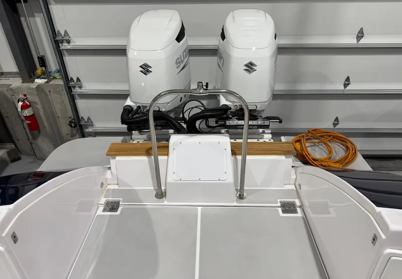 Slide: The Image of 2022 True North 34 Outboard Express boat with dual Suzuki engines in a garage. - 21