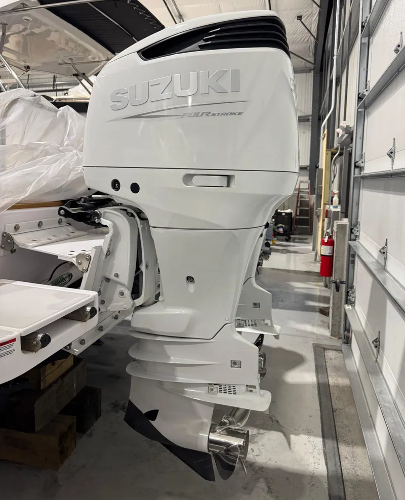 Slide: The Image of 2022 True North 34 Outboard Express with Suzuki engine in a garage setting. - 22