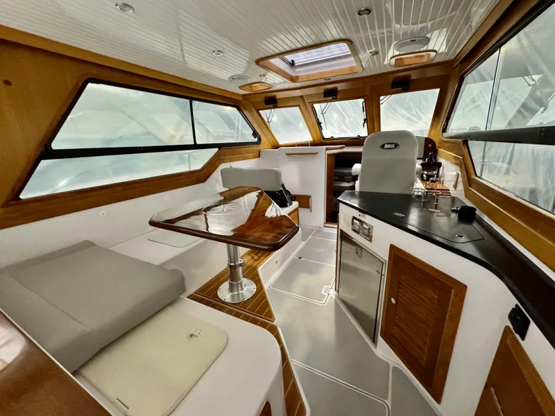 Slide: The Image of Interior of 2022 True North 34 Outboard Express boat with modern kitchen and seating area. - 3