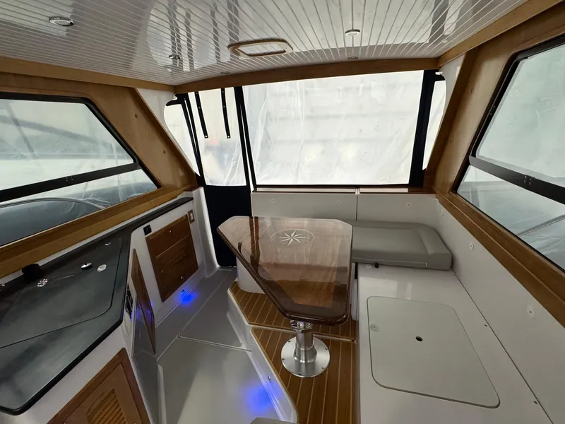 Slide: The Image of Interior of 2022 True North 34 Outboard Express with modern seating and wooden accents. - 4