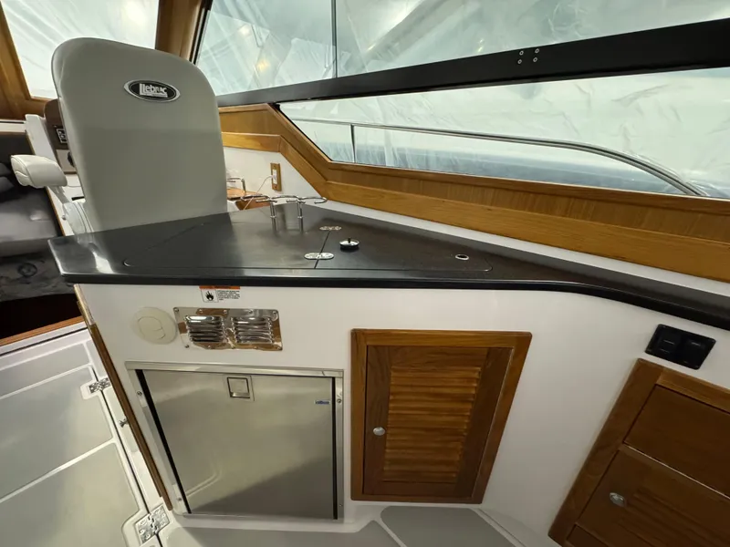 Slide: The Image of 2022 True North 34 Outboard Express interior with sleek counter and wooden cabinetry. - 7
