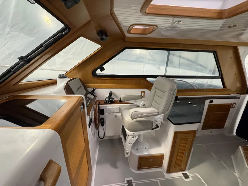 Slide: The Image of 2022 True North 34 Outboard Express interior with helm station and seating. - 9