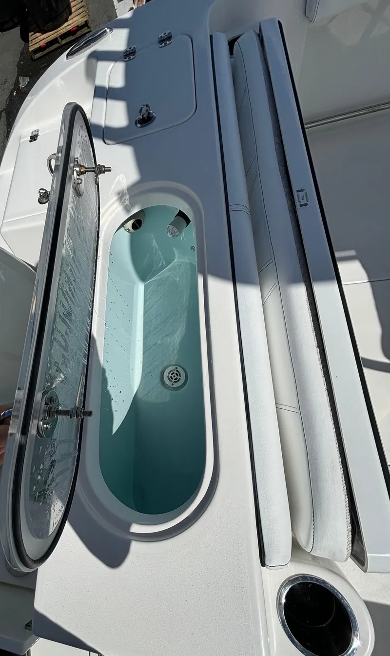 Slide: The Image of 2021 Sea Pro 219 Center Console boat with open livewell and seating area. - 12