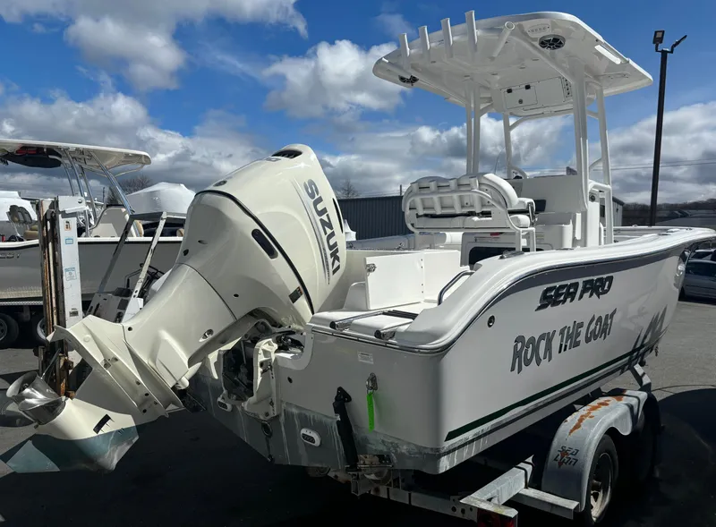 Slide: The Image of 2021 Sea Pro 219 Center Console boat with Suzuki engine on trailer, under cloudy sky. - 3