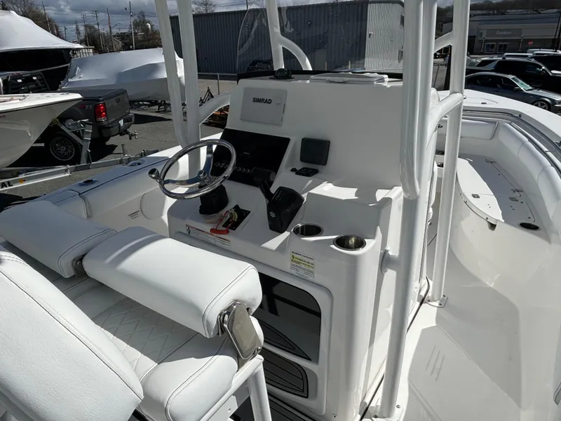 Slide: The Image of 2021 Sea Pro 219 Center Console boat interior with steering wheel and control panel. - 5