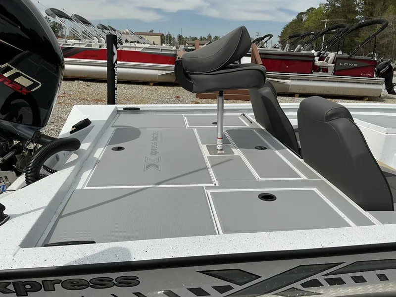 Slide: The Image of 2025 Xpress Hyper-Lift Bass Series boat deck with seating and storage compartments. - 12