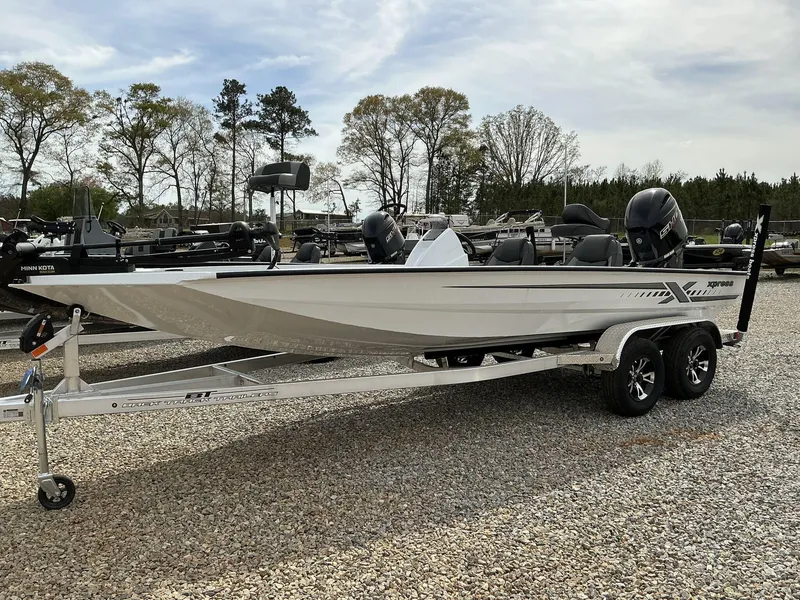 Slide: The Image of 2025 Xpress Hyper-Lift Bass Series boat on trailer, parked outdoors. - 2