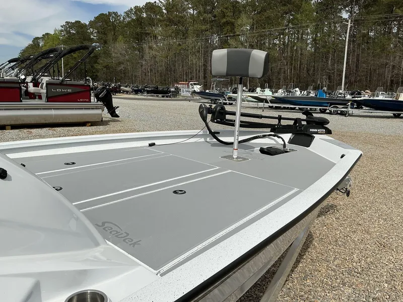 Slide: The Image of 2025 Xpress Hyper-Lift Bass Series boat with Minn Kota trolling motor, parked outdoors. - 7