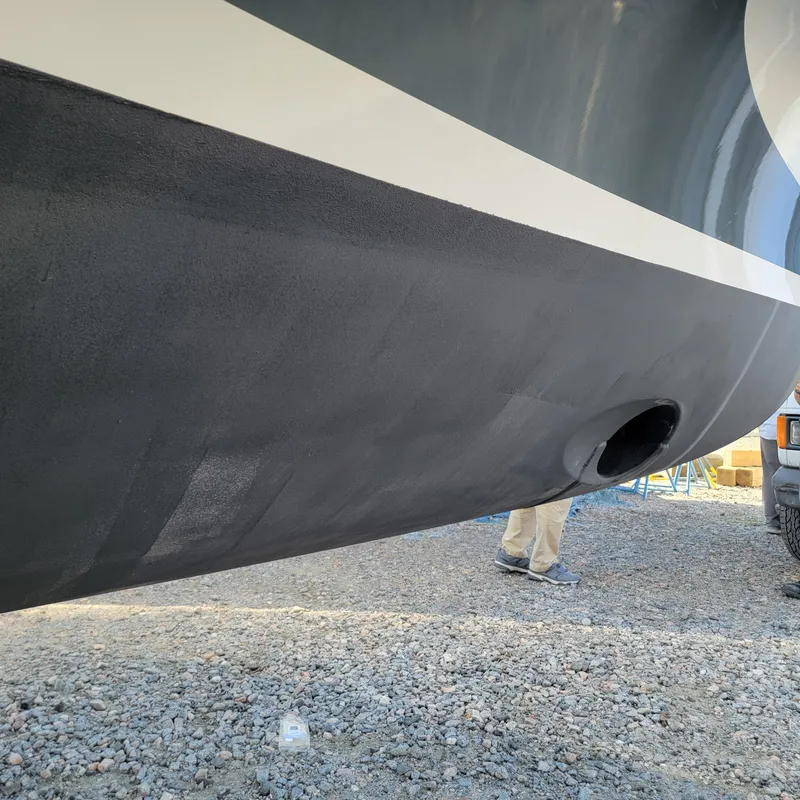 Slide: The Image of 2022 Greenline 40 Hybrid boat hull on gravel, close-up view. - 15