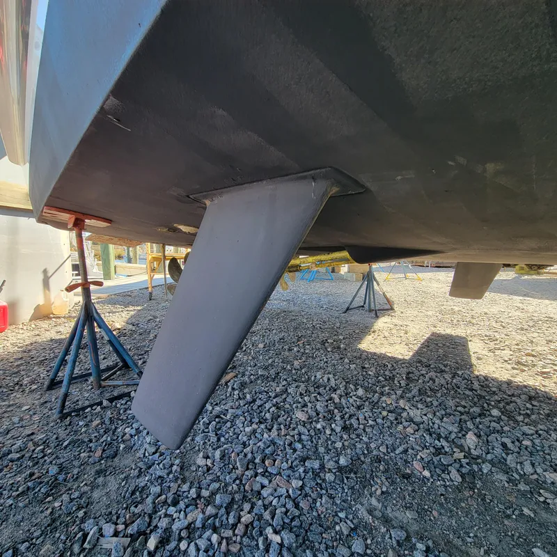 Slide: The Image of Underneath view of a 2022 Greenline 40 Hybrid boat on a gravel surface. - 16