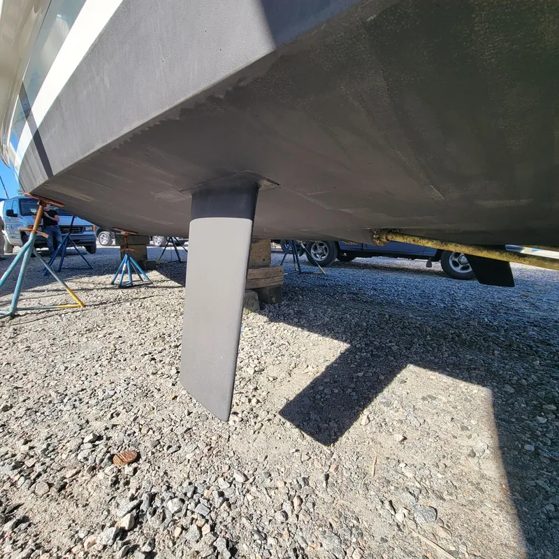 Slide: The Image of Underneath view of a 2022 Greenline 40 Hybrid boat on gravel. - 21