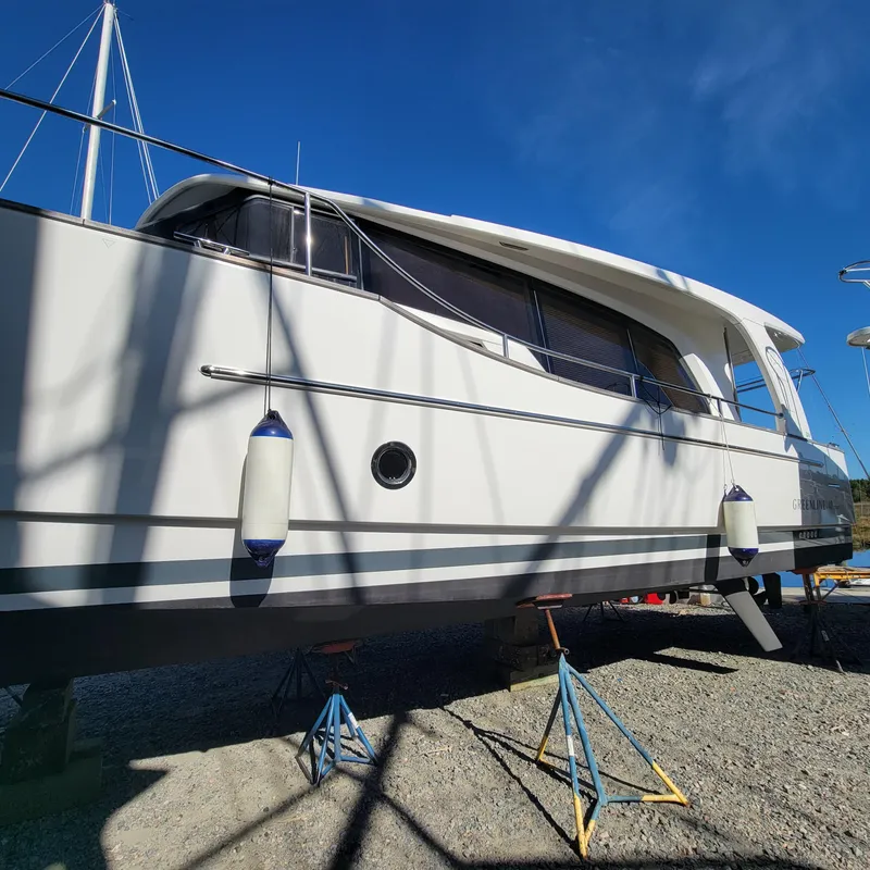 Slide: The Image of 2022 Greenline 40 Hybrid yacht on stands, side view under clear blue sky. - 23