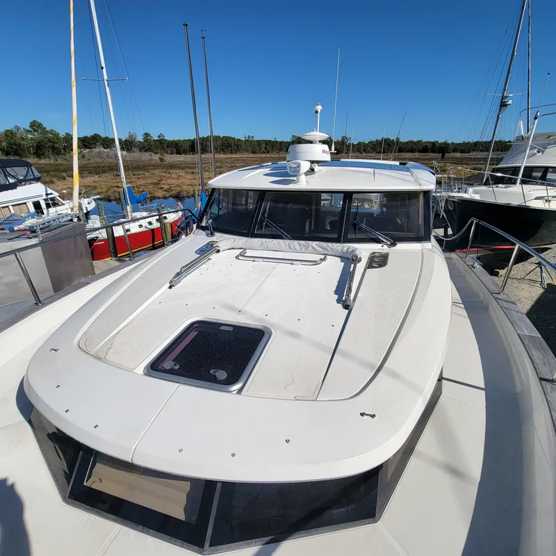Slide: The Image of 2022 Greenline 40 Hybrid yacht docked under clear blue sky. - 27