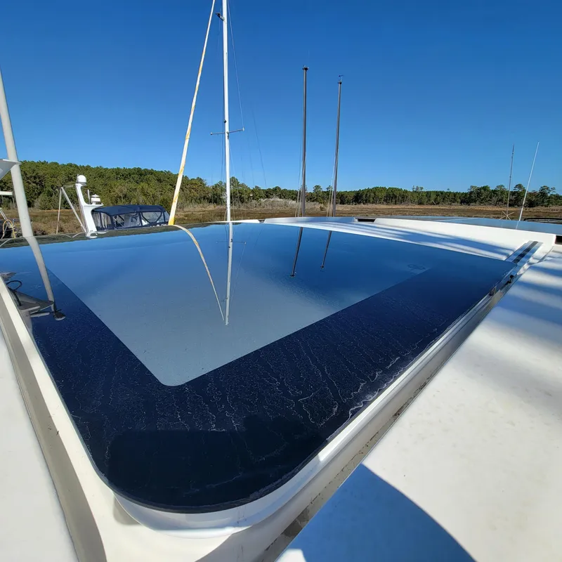 Slide: The Image of 2022 Greenline 40 Hybrid yacht with solar panels under clear blue sky. - 29