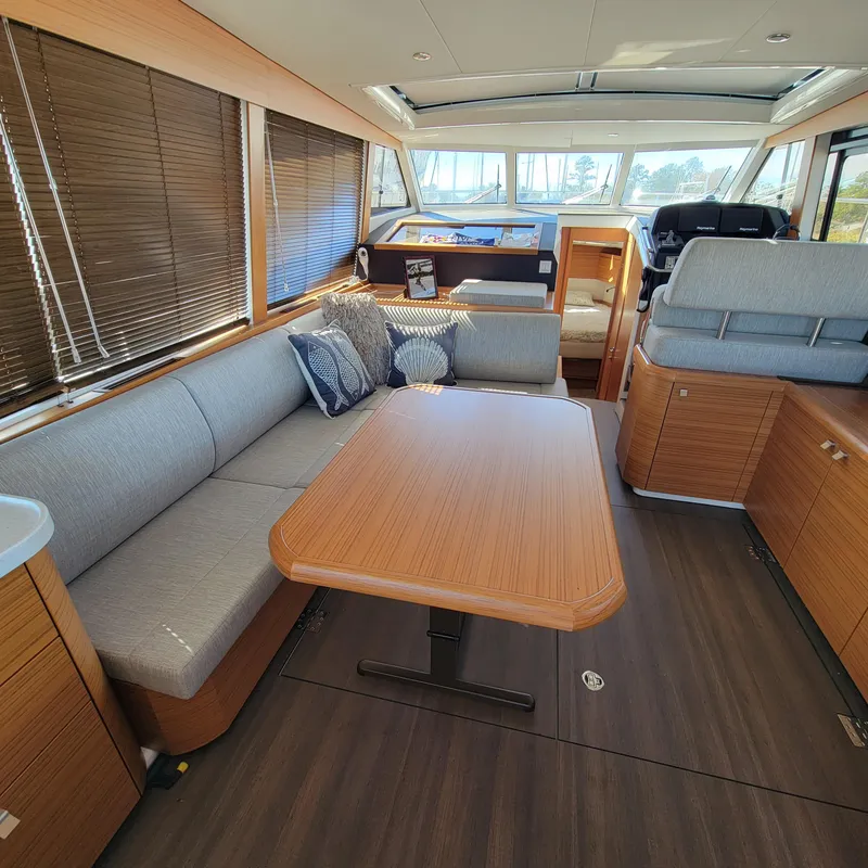 Slide: The Image of Interior of 2022 Greenline 40 Hybrid yacht with modern seating and wooden table. - 38
