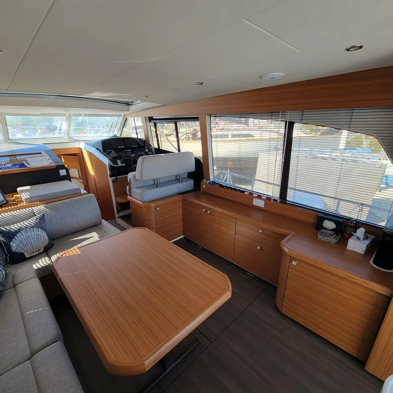 Slide: The Image of Interior of 2022 Greenline 40 Hybrid yacht with modern wood finish and seating area. - 39