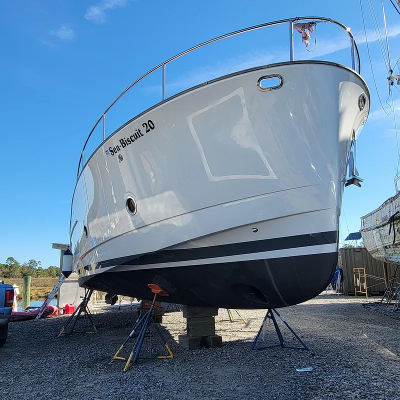 Slide: The Image of 2022 Greenline 40 Hybrid boat on stands, named "Sea Biscuit 20," under clear blue sky. - 4